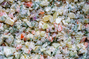 Healthy homemade russian traditional salad olivier ready to eat, close up