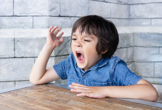 Portrait tired child yawning, Little boy get a cold during weather change,  Child having allergy. kid has reflection or hay fever from dust mite,  Allergies in kids, Children health care concept Stock