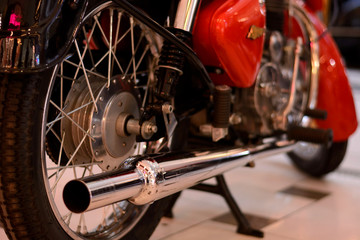Fototapeta na wymiar Motorcycle engine and exhaust pipe closeup. Retro bike shiny classic metal details