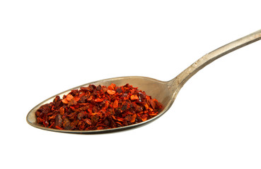 Mixing slices of pepper in an old spoon isolated on a white background. View from above. Spices in a spoon on isolate.