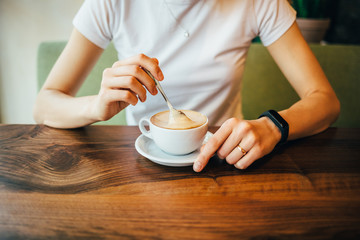 Female's hands stir with spoon