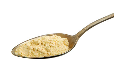 Ginger powder in a spoon isolated on a white background. View from above. Spaces on the isolate.