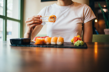 Unrecognizable young woman eating