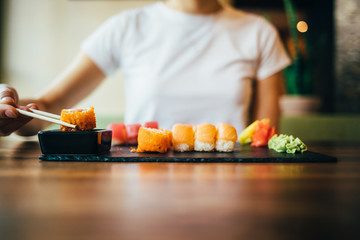 Young woman dipping roll