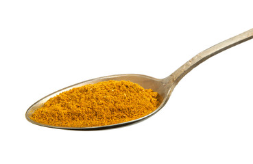 Curry in an old spoon isolated on a white background. Spice on isolate. View from above.