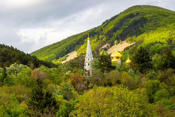 Fototapeta na wymiar Shipka Memorial Church tucked between the trees of the Balkan Mountains forest in Bulgaria