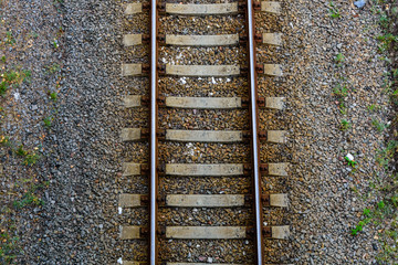 Top view of the railroad tracks on gravel