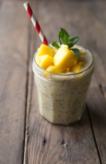 Beautiful and tasty dessert with mango and seeds of a chia. A fresh pudding with fruit for breakfast
