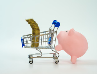 piggy bank pushing shopping cart with coins on top, White background