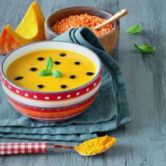 Spicy pumpkin soup with red lentils and turmeric served with min