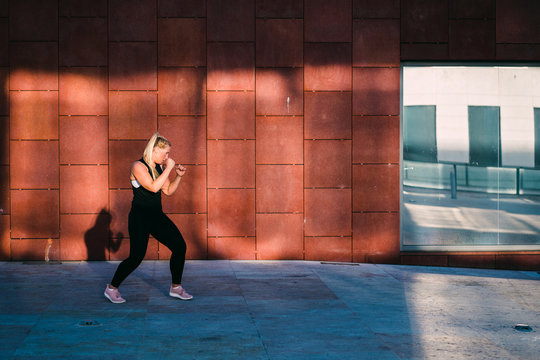 Woman shadow boxing early in the morning in Lisbon