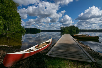 jetty and red canoe, Stora Hensjön lake, Tingsryd , Smaland, Sweden