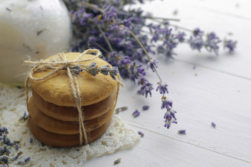 Tasty homemade lavender cookies on light wooden background