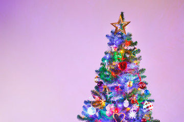 Christmas tree with multicolor led lights and copy-space background