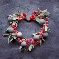 Christmas flat lay with mistletoe wreath on dark