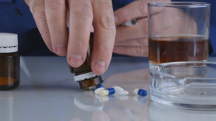 Close Up Image with Man Taking Pills and Drinking Alcohol