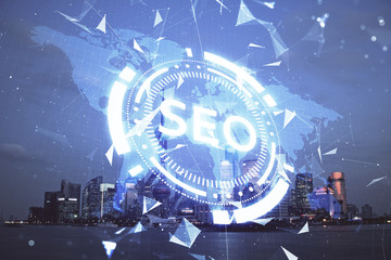 SEO hologram on city view with skyscrapers background double exposure. Search optimization concept.