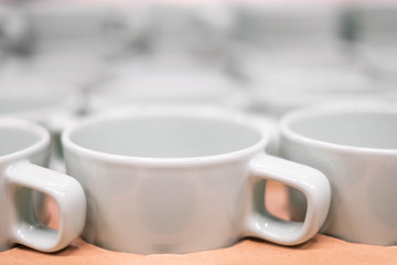 Closeup of White ceramic cup on the shelf.Closeup of Ceramic glass on the shelf.