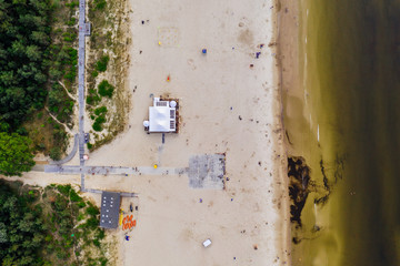 Aerial drone photography of the crowd of people on the beach. Sandy Baltic shore, northern Poland. 