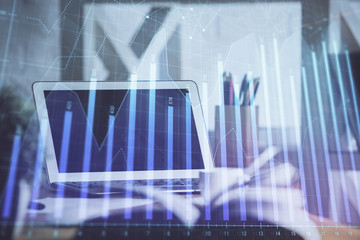 Stock market graph and table with computer background. Double exposure. Concept of financial analysis.