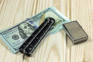 knife and a lighter next to money, concept, crime, contract kill