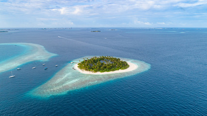 Aerial view of beautiful island at Maldives in the Indian Ocean. Top view from drone.