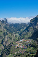 Fototapeta na wymiar Panoramic mountains view from Eira do Serrado viewpoint down to Curral das Freiras through the Nun's Valley on Madeira Island