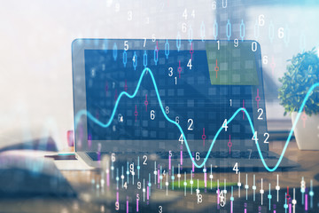 Stock market chart hologram drawn on personal computer background. Multi exposure. Concept of investment.