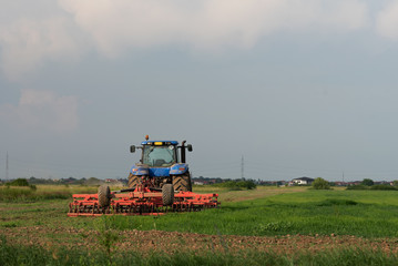 A tractor working on the field
