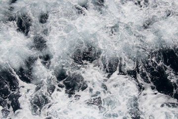 Obraz premium Background of the sea. Sea, ocean, wave. Beautiful view of the bubbling and splashing sea water and foam in the blue sea.