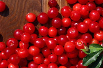 Ripe cherry on a wooden table, cherry on a branch