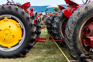 Obraz premium row of large vintage tractors on display at antique tractor show