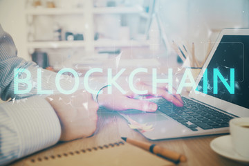 Blockchain theme hud with man working on computer on background. Concept of crypto chain. Double exposure.