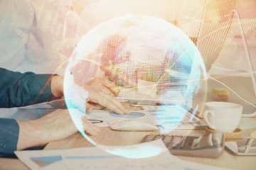 Double exposure of businessman working on laptop on background. International business hologram in front. Concept of success.