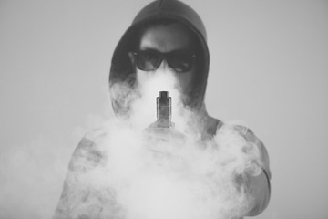Vaping man and a cloud of vapor