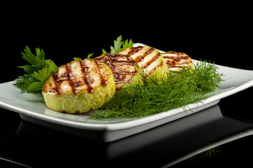 Concept for a healthy summer diet: baked zucchini with dill sauce