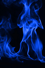 Obraz premium Beautiful fire blue flames on a black background.