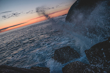 sunset over sea with sea spray
