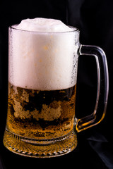 glass of beer on a black background