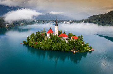 Bled, Slovenia - Beautiful foggy morning at Lake Bled (Blejsko Jezero) with the Pilgrimage Church...