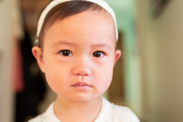 crying baby with tears in eyes, close up of face