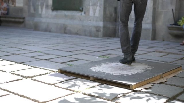 feet of a man dancing tap dance n the street