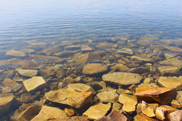 Pure cold clear water and stones. Close-up. Beautiful beach. Background. Landscape.