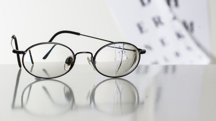 Old glasses on a table in a white room.