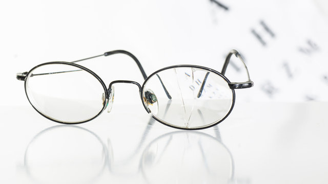 Old glasses on a table in a white room.