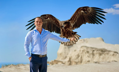 man in a shirt with an eagle on his hand