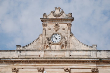 The clock on one of the historic buildings in the main piazza in Ostuni, southern Italy
