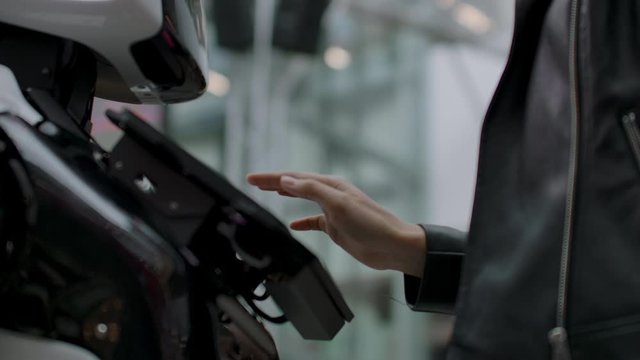 A female programmer tests the robot for the ability to interact with users. The use of a robot assistant in the office. The robot gives help to the girl.