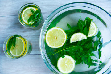 making mojito drink top view on a light wood background. Hot Summer. refreshing drink