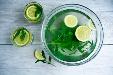making mojito drink top view on a light wood background. Hot Summer. refreshing drink